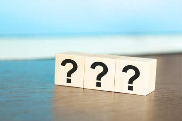 3 wooden blocks of question marks depicting FAQs about fuel oil company
