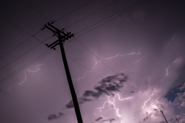 lightnings near electric post depicting power surge
