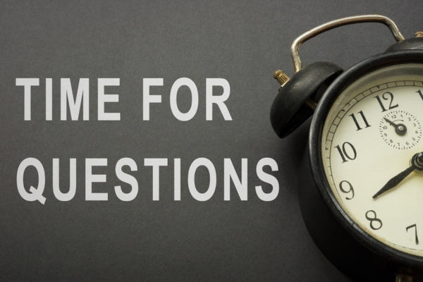 time for questions written on black paper beside an alarm clock depicting common questions about flushable wipes