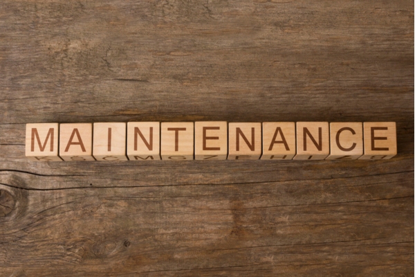 MAINTENANCE word on wooden cubes depicting oil heating system