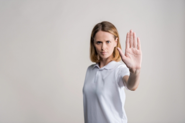 woman doing stop sign using hand depicting Stopping Sewer Odors Before They Start