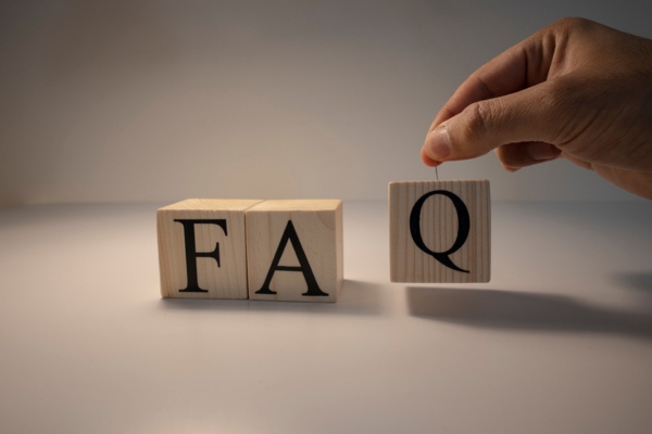 FAQ spelled using wooden letter cubes depicting questions about Shower Squealing Noise
