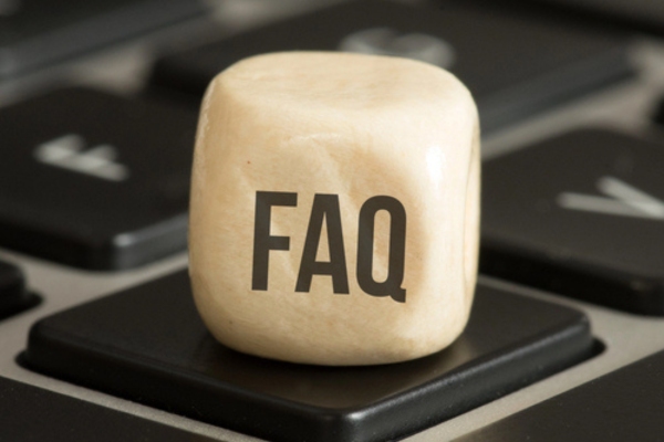 FAQ written on a wooden dice on top of a keyboard depicting questions about Trane HVAC Upgrade