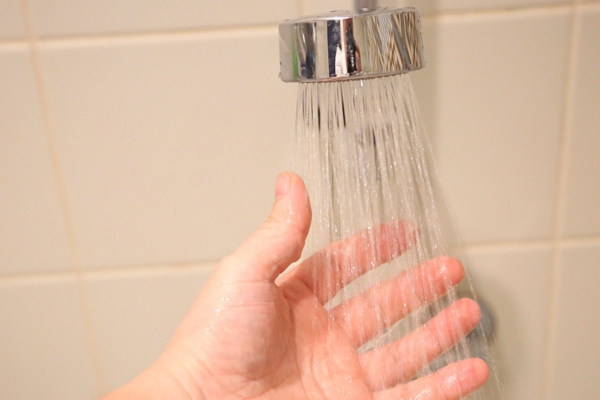 man checking shower water pressure