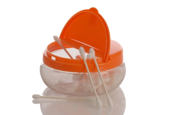 image of cotton balls and swabs in a container with orange lid