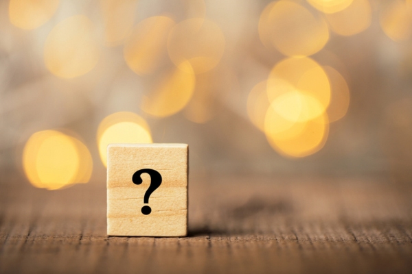question mark on a wooden chip depicting common questions about hot and cold spots in house
