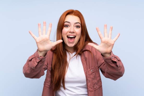 woman holding 10 fingers up depicting Items You Should Never Flush