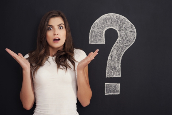 woman looking worried while shrugging beside a doodle of a big question mark depicting What to Do If You Suspect You Have Old House Wiring
