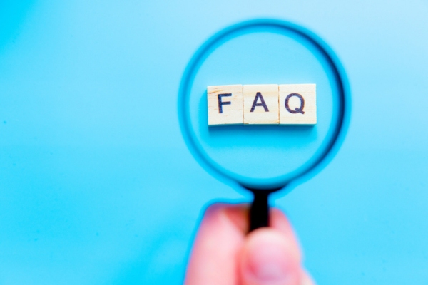 Magnifying glass on wood letters spelling FAQ depicting questions about Furnace Preparation Tips