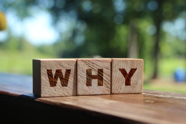 WHY spelled using wooden letter cubes depicting needing oil additives