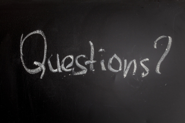 Questions written on a chalkboard depicting FAQs about getting oil heat radiator ready