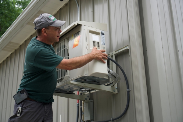 Noonan Energy HVAC technician tending to Mitsubishi ductless outdoor unit