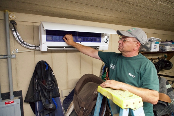Noonan Energy HVAC technician tending to a Mitsubishi ductless indoor unit