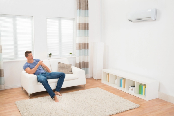 man operating ductless air conditioner