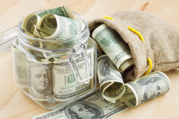 rolls of money in a jar and bag