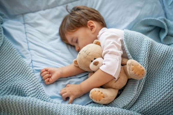 toddler sleeping while hugging teddy bear depicting Ultra Quiet Mini-Split Operation