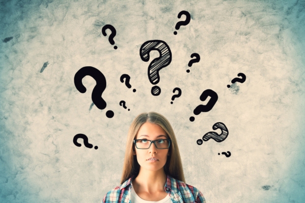 woman looking up at question mark doodles depicting Oil Storage Tank Design FAQs