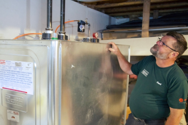 Noonan Energy staff examining an oil tank