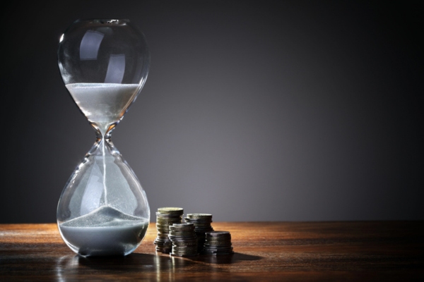 hourglass beside coins depicting Maximize Your Time and Reduce Heating Expenses