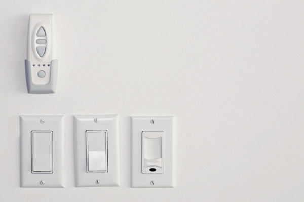 White electrical outlet and switches on a wall