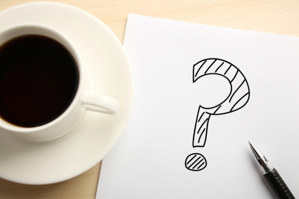 question mark doodled on paper beside a coffee cup depicting Bathroom Upgrade