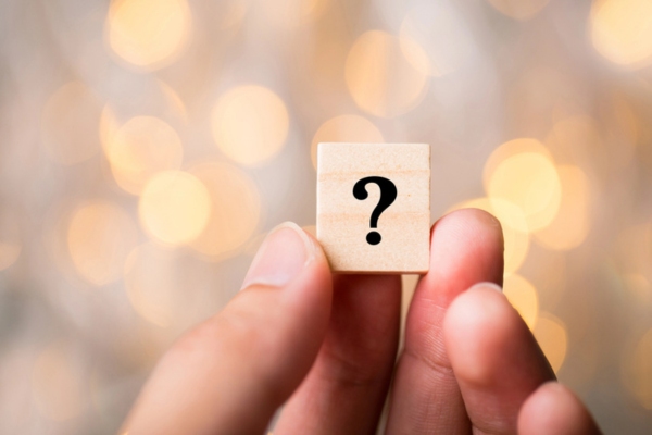 hand holding a question mark wooden chip depicting Heating Oil in Summer FAQs