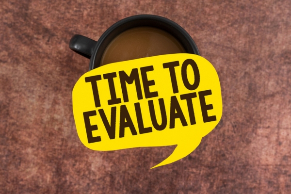 speech bubble cutout that says time to evaluate depicting heating oil in summer