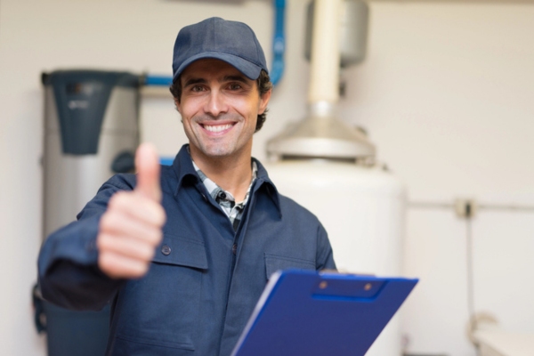 plumber doing a thumbs up during a plumbing service for a house