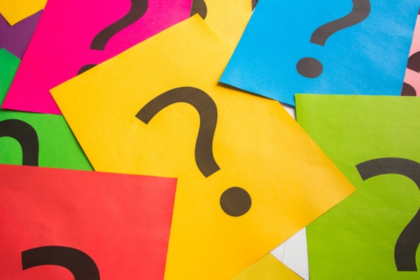 question mark on colored papers depicting Oil Heating System Maintenance FAQs
