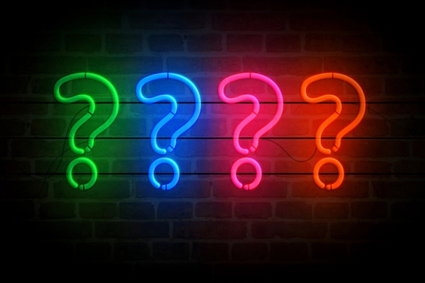 neon lights formed into question marks depicting Outdoor Lighting Installation FAQs