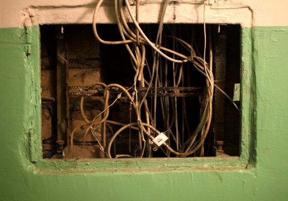 old electrical panel on the wall of the house