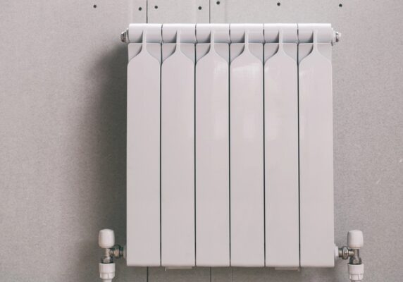 white heating radiator against the wall